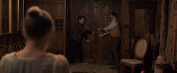 Movie still from “You're Next” (2011), directed by Adam Wingard – Two men are playing a video game in a room; Medium shot, Over the shoulder angle