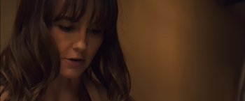 Movie still from “You're Next” (2011), directed by Adam Wingard – A person with long brown hair; Close Up shot, Over the shoulder angle