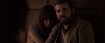 Movie still from “You're Next” (2011), directed by Adam Wingard – A man and a woman sitting next to each other; Medium shot, Over the shoulder angle