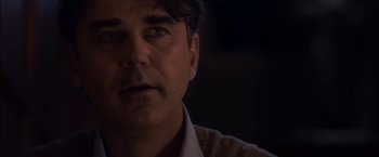 Movie still from “You're Next” (2011), directed by Adam Wingard – A person looking at the camera; Close Up shot, Over the shoulder angle