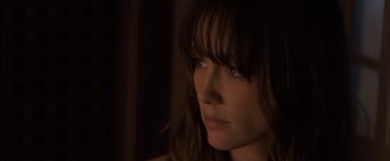 Movie still from “You're Next” (2011), directed by Adam Wingard – A person looking at the camera; Close Up shot, Over the shoulder angle