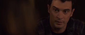 Movie still from “You're Next” (2011), directed by Adam Wingard – A person looking at the camera; Close Up shot, Over the shoulder angle