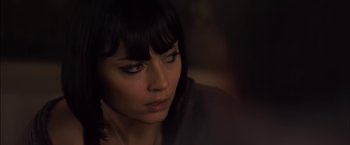 Movie still from “You're Next” (2011), directed by Adam Wingard – A person with bangs looking at the camera; Close Up shot, Over the shoulder angle