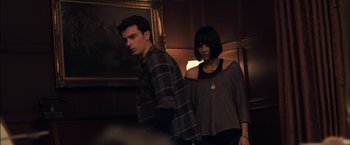 Movie still from “You're Next” (2011), directed by Adam Wingard – A man and a woman standing next to each other in a room; Medium shot, Low angle