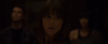 Movie still from “You're Next” (2011), directed by Adam Wingard – A person with long brown hair; Close Up shot, Over the shoulder angle