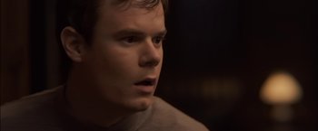 Movie still from “You're Next” (2011), directed by Adam Wingard – A person looking at the camera; Close Up shot, High angle