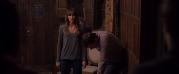 Movie still from “You're Next” (2011), directed by Adam Wingard – A man and a woman are standing in front of a mirror; Medium shot, Over the shoulder angle