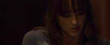 Movie still from “You're Next” (2011), directed by Adam Wingard – A person looking down at her face; Close Up shot, High angle