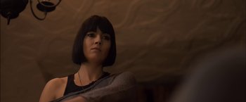 Movie still from “You're Next” (2011), directed by Adam Wingard – A person with short black hair; Close Up shot, Low angle