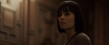 Movie still from “You're Next” (2011), directed by Adam Wingard – A person with short black hair; Close Up shot, Low angle