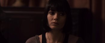 Movie still from “You're Next” (2011), directed by Adam Wingard – A person wearing a necklace; Close Up shot, Over the shoulder angle