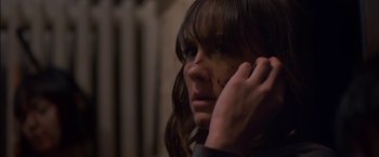 Movie still from “You're Next” (2011), directed by Adam Wingard – A young woman with blood all over her face; Close Up shot, Over the shoulder angle