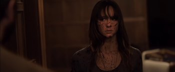 Movie still from “You're Next” (2011), directed by Adam Wingard – A person wearing a black shirt; Close Up shot, High angle