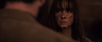 Movie still from “You're Next” (2011), directed by Adam Wingard – A young woman looking into a mirror with blood on her face; Close Up shot, Over the shoulder angle