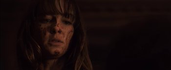 Movie still from “You're Next” (2011), directed by Adam Wingard – A person with a face covered in dirt; Close Up shot, Low angle