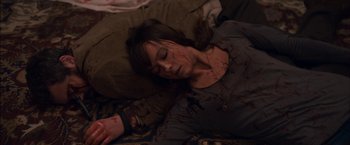 Movie still from “You're Next” (2011), directed by Adam Wingard – A woman laying on the ground with blood all over her face; Medium shot, Overhead angle