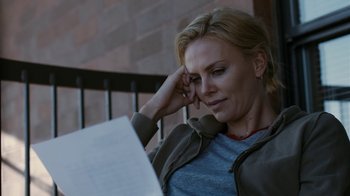 Movie still from “Young Adult” (2011), directed by Jason Reitman – A woman sitting on a porch looking at a sheet of paper; Close Up shot, High angle