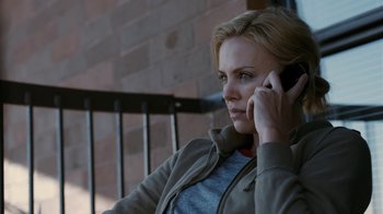 Movie still from “Young Adult” (2011), directed by Jason Reitman – A woman sitting outside talking on a cell phone; Close Up shot, Over the shoulder angle