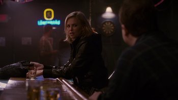 Movie still from “Young Adult” (2011), directed by Jason Reitman – A woman sitting at a bar talking to a man; Medium shot, Over the shoulder angle