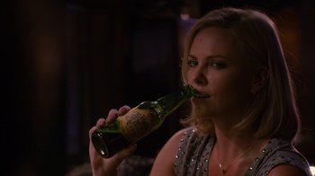 Movie still from “Young Adult” (2011), directed by Jason Reitman – A woman is drinking a beer from a bottle; Close Up shot, High angle