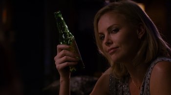 Movie still from “Young Adult” (2011), directed by Jason Reitman – A beautiful woman holding a bottle of beer; Close Up shot, Over the shoulder angle