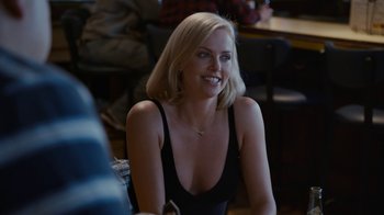 Movie still from “Young Adult” (2011), directed by Jason Reitman – A woman sitting at a table in front of other people; Close Up shot, Over the shoulder angle