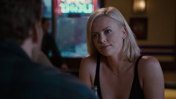 Movie still from “Young Adult” (2011), directed by Jason Reitman – A woman sitting in front of a man in front of a window; Close Up shot, Over the shoulder angle