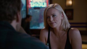 Movie still from “Young Adult” (2011), directed by Jason Reitman – A woman sitting in front of a man in front of a window; Close Up shot, Over the shoulder angle