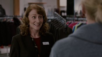 Movie still from “Young Adult” (2011), directed by Jason Reitman – A woman in a black jacket is talking to a man in a suit; Medium shot, Over the shoulder angle