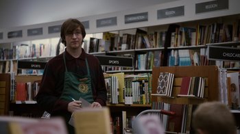Movie still from “Young Adult” (2011), directed by Jason Reitman – A man standing in front of a book shelf in a store; Medium shot, Over the shoulder angle