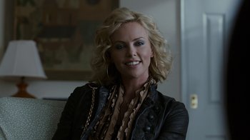Movie still from “Young Adult” (2011), directed by Jason Reitman – Charlize theron smiling for the camera; Close Up shot, Over the shoulder angle