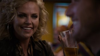 Movie still from “Young Adult” (2011), directed by Jason Reitman – A woman sitting next to a man holding a glass of beer; Close Up shot, Over the shoulder angle
