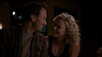 Movie still from “Young Adult” (2011), directed by Jason Reitman – A man and a woman smiling at each other; Close Up shot, Over the shoulder angle