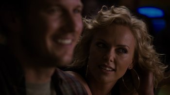 Movie still from “Young Adult” (2011), directed by Jason Reitman – A man and a woman smiling for the camera; Close Up shot, Over the shoulder angle