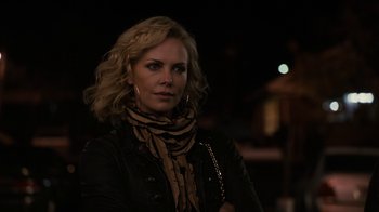 Movie still from “Young Adult” (2011), directed by Jason Reitman – A woman with blonde curly hair wearing a leather jacket; Close Up shot, Over the shoulder angle