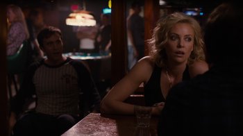 Movie still from “Young Adult” (2011), directed by Jason Reitman – Charlize theron sitting at a table in front of a man; Medium shot, Over the shoulder angle