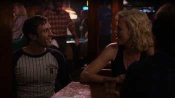 Movie still from “Young Adult” (2011), directed by Jason Reitman – A man and a woman sitting at a table talking to each other; Medium shot, Over the shoulder angle