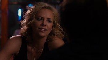 Movie still from “Young Adult” (2011), directed by Jason Reitman – A beautiful blonde woman with a smile on her face; Close Up shot, Over the shoulder angle