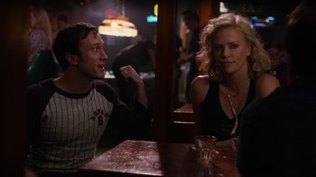 Movie still from “Young Adult” (2011), directed by Jason Reitman – A man and a woman are sitting at a table; Medium shot, Over the shoulder angle