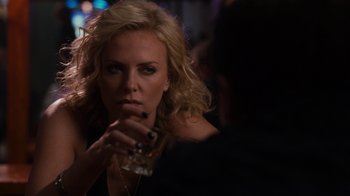 Movie still from “Young Adult” (2011), directed by Jason Reitman – A woman holding a drink in her hand and looking at the camera; Close Up shot, Over the shoulder angle