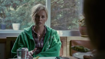 Movie still from “Young Adult” (2011), directed by Jason Reitman – A woman sitting at a table in front of a window; Medium shot, Over the shoulder angle
