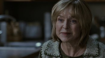 Movie still from “Young Adult” (2011), directed by Jason Reitman – An older woman is looking at the camera; Close Up shot, Over the shoulder angle