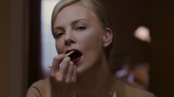 Movie still from “Young Adult” (2011), directed by Jason Reitman – A woman eating a piece of food with her hands; Close Up shot, High angle