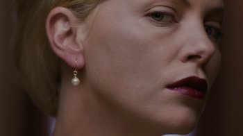 Movie still from “Young Adult” (2011), directed by Jason Reitman – A person wearing a pair of earrings; Extreme Close Up shot, Low angle