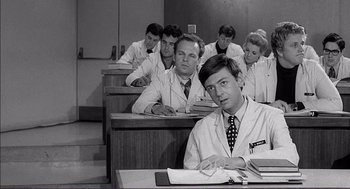 Movie still from “Young Frankenstein” (1974), directed by Mel Brooks – Black and white photograph of a group of men in lab coats; Medium shot, Low angle