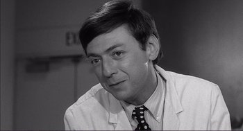 Movie still from “Young Frankenstein” (1974), directed by Mel Brooks – Black and white photograph of a man wearing a white lab coat; Close Up shot, Low angle