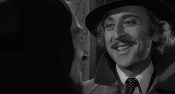 Movie still from “Young Frankenstein” (1974), directed by Mel Brooks – Gene wilder in a hat and coat; Close Up shot, Over the shoulder angle