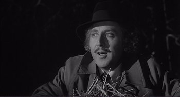 Movie still from “Young Frankenstein” (1974), directed by Mel Brooks – A person wearing a suit and hat; Close Up shot, Low angle