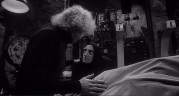 Movie still from “Young Frankenstein” (1974), directed by Mel Brooks – A man and a woman are sitting in a room; Medium shot, Over the shoulder angle