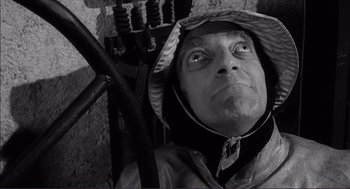 Movie still from “Young Frankenstein” (1974), directed by Mel Brooks – A man with a hat on looking into the distance; Close Up shot, Low angle